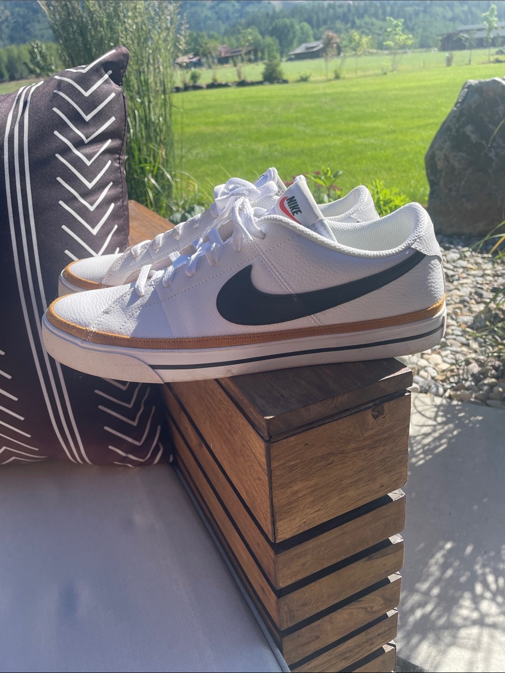 Nike White Low-Top Sneakers with Black Swoosh and Gold Accent